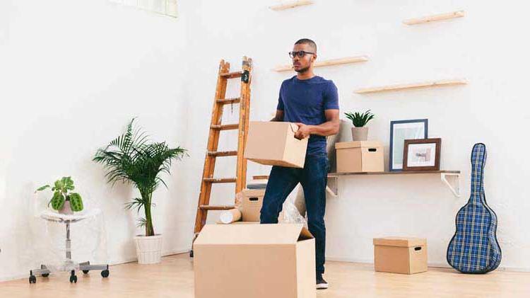 Man packing up his apartment.