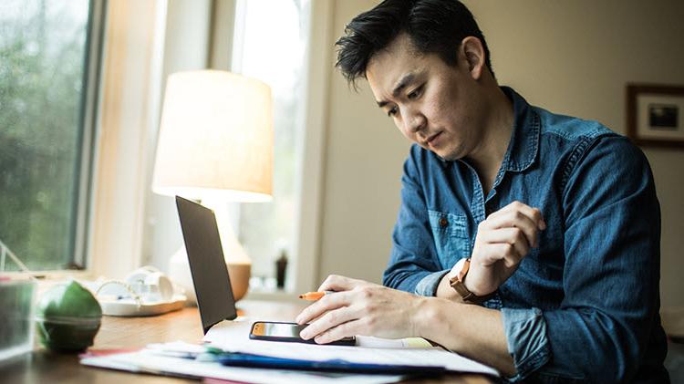 Man reviewing finances with his laptop.